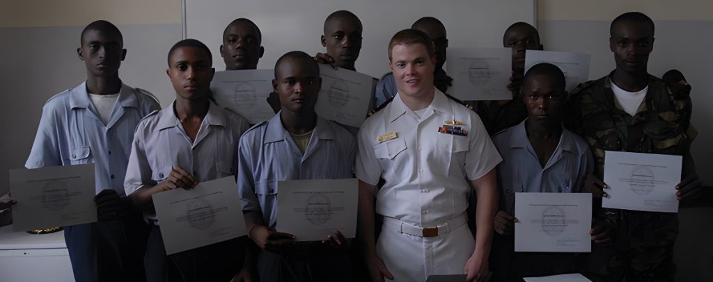 naval officer with class holding certificates