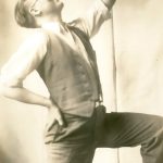 Harry Hoijer kneeling holding a flower